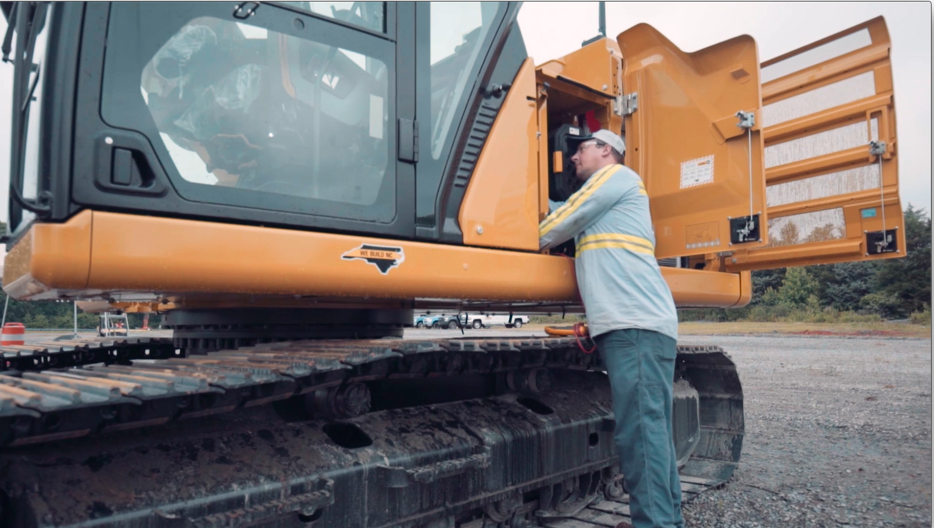 A worker trying to help maintain the heavy equipment