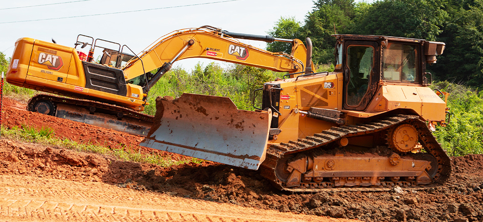 Image of rented Cat dozer and excavator digging dirt.